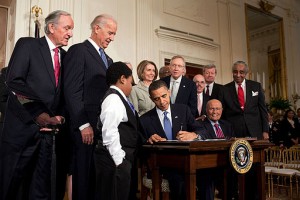 Barack Obama signing the Patient Protection and Affordable Care Act at the White House. Photo by Pete Souza [CC BY 2.0], via Wikimedia Commons  http://creativecommons.org/licenses/by/2.0