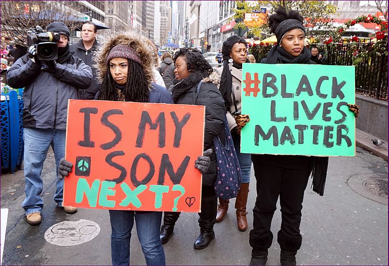 NYC action in solidarity with Ferguson. Mo, encouraging a boycott of Black Friday Consumerism. Photo via Wilimedia Commons
